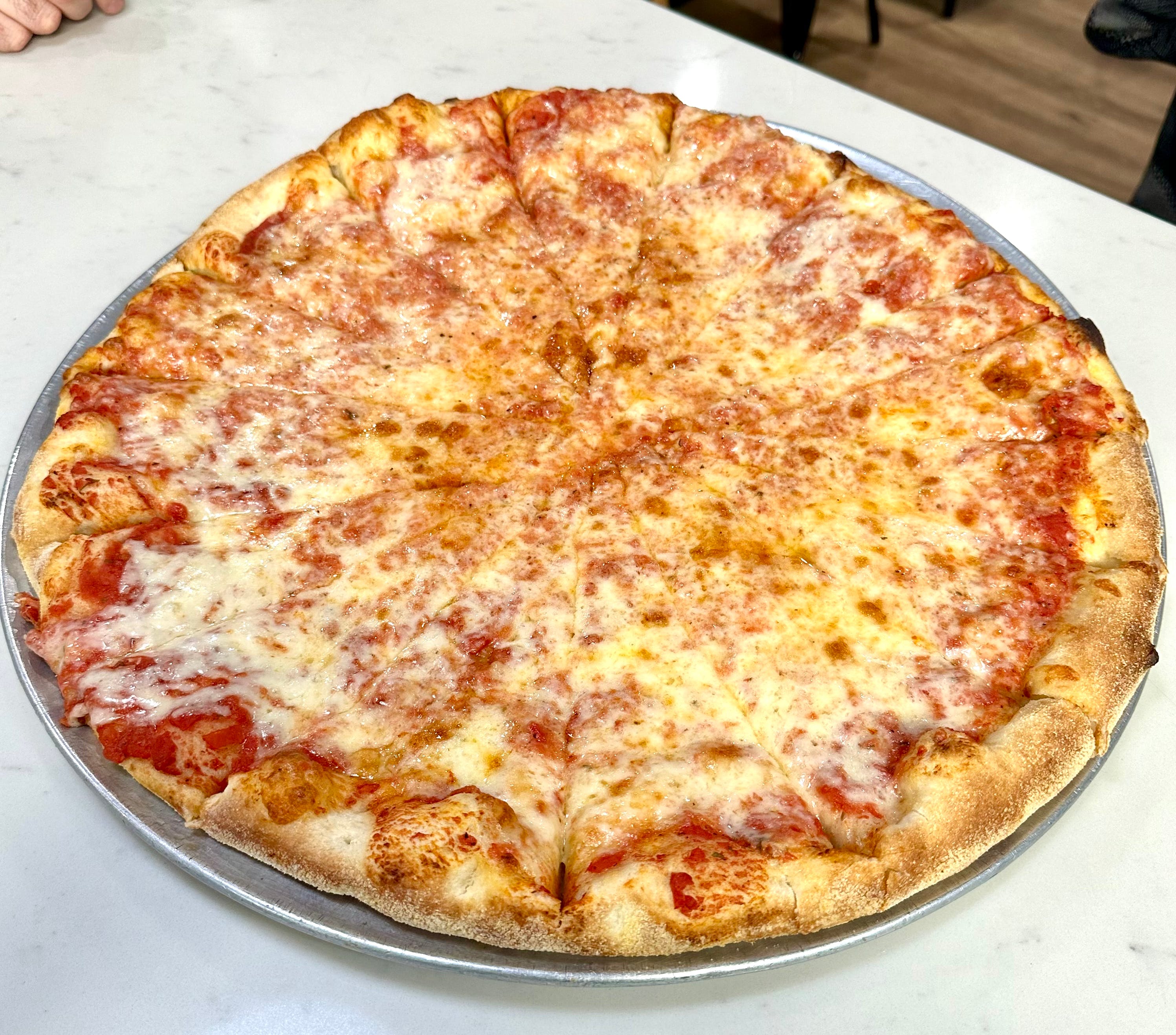 Fresh cheese pizza on tray at Pizza Mark LA