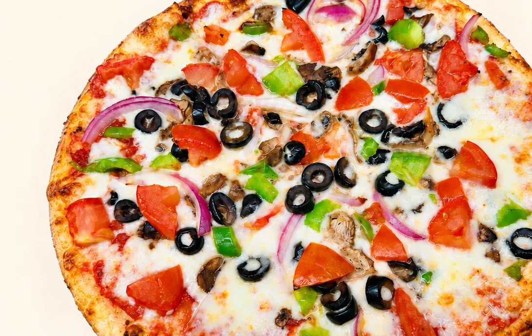 Vegetable pizza with olives, peppers, onions, tomatoes and mushrooms